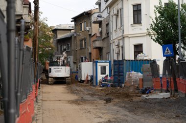 Construction workers at construction site and heavy duty bulldozer in Bucharest, Romania, 2023