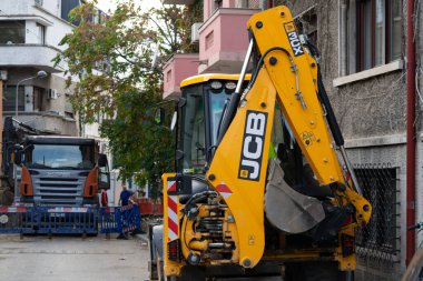 Construction workers at construction site and heavy duty bulldozer in Bucharest, Romania, 2023