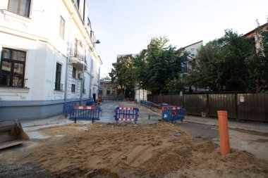 Construction workers at construction site and heavy duty bulldozer in Bucharest, Romania, 2023