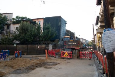 Construction workers at construction site and heavy duty bulldozer in Bucharest, Romania, 2023