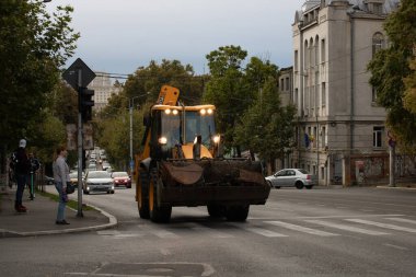 Construction workers at construction site and heavy duty bulldozer in Bucharest, Romania, 2023