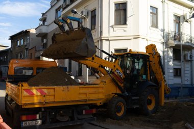 Construction workers at construction site and heavy duty bulldozer in Bucharest, Romania, 2023