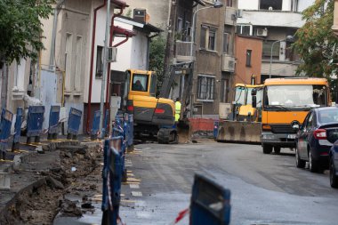 Construction workers at construction site and heavy duty bulldozer in Bucharest, Romania, 2023
