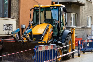 Construction workers at construction site and heavy duty bulldozer in Bucharest, Romania, 2023