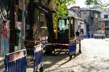 Construction workers at construction site and heavy duty bulldozer in Bucharest, Romania, 2023