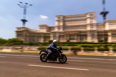 Biker on a motorcycle in traffic at rush hour in downtown area of the city in Bucharest, Romania, 2022