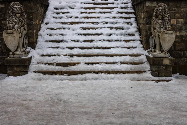 Stairs covered with fresh snow. Danger of accident on snow-covered slippery steps