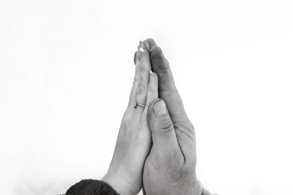 Touching hands, father with hard worked hand giving high five with his daughter. Close up