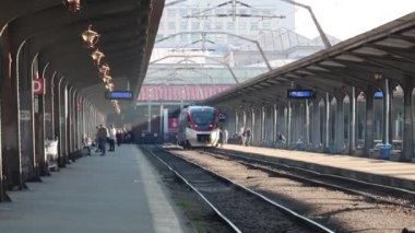 Train in motion at train platform at North Rail station (Gara de Nord). Train transport infrastructure. Bucharest, Romania, 2023