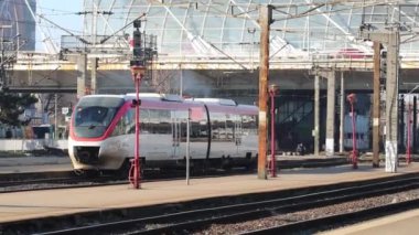 Train in motion at train platform at North Rail station (Gara de Nord). Train transport infrastructure. Bucharest, Romania, 2023