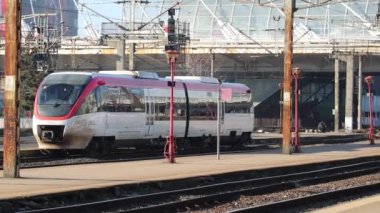 Train in motion at train platform at North Rail station (Gara de Nord). Train transport infrastructure. Bucharest, Romania, 2023