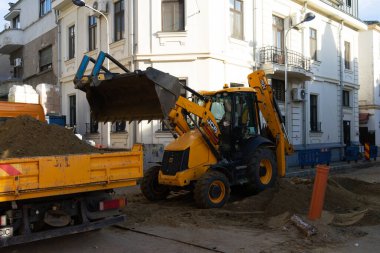 Construction workers at construction site and heavy duty bulldozer in Bucharest, Romania, 2023