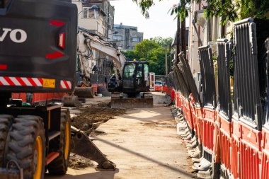 Construction workers at construction site and heavy duty bulldozer in Bucharest, Romania, 2023