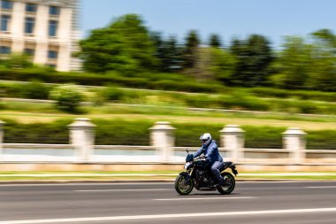 Biker on a motorcycle in traffic at rush hour in downtown area of the city in Bucharest, Romania, 2022