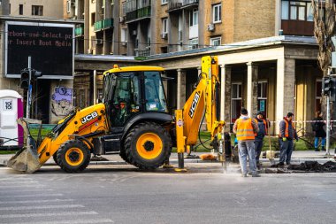 Excavator in traffic. industrial equipment at construction site in Bucharest, Romania, 2023