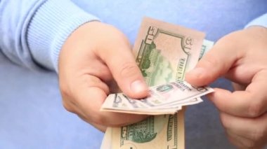 Man counting and showing US Dollar money. Counting USD banknotes