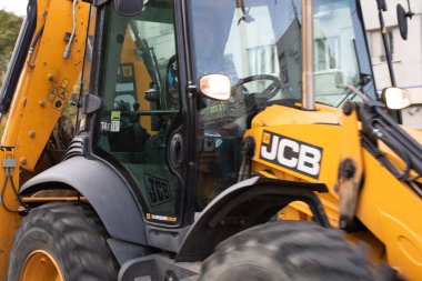 Construction workers at construction site and heavy duty bulldozer in Bucharest, Romania, 2023