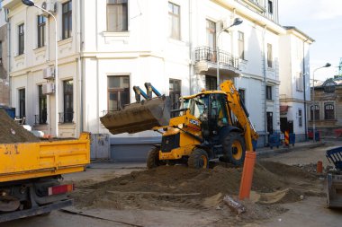 Construction workers at construction site and heavy duty bulldozer in Bucharest, Romania, 2023