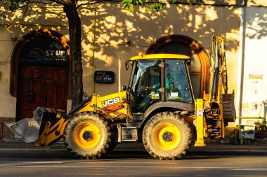 Excavator in traffic. industrial equipment at construction site in Bucharest, Romania, 2023