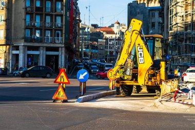 Excavator in traffic. industrial equipment at construction site in Bucharest, Romania, 2023