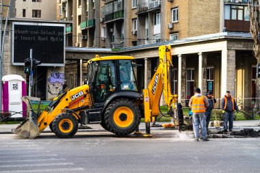 Excavator in traffic. industrial equipment at construction site in Bucharest, Romania, 2023