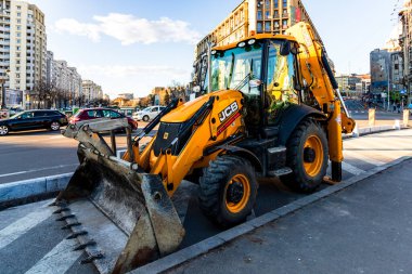 Excavator in traffic. industrial equipment at construction site in Bucharest, Romania, 2023