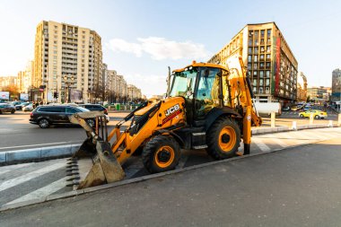 Excavator in traffic. industrial equipment at construction site in Bucharest, Romania, 2023