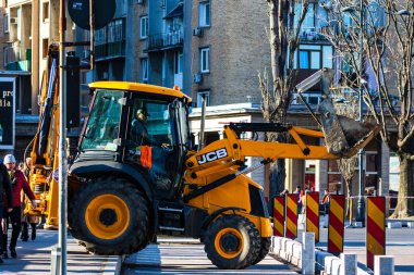 Excavator in traffic. industrial equipment at construction site in Bucharest, Romania, 2023