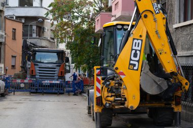 Construction workers at construction site and heavy duty bulldozer in Bucharest, Romania, 2023