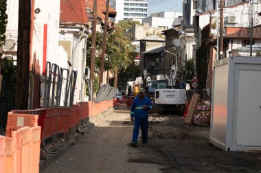 Construction workers at construction site and heavy duty bulldozer in Bucharest, Romania, 2023