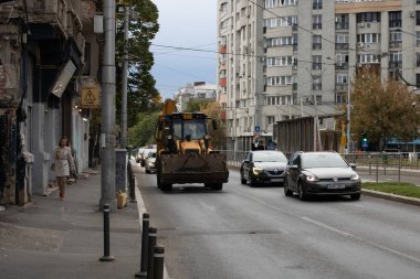 Construction workers at construction site and heavy duty bulldozer in Bucharest, Romania, 2023
