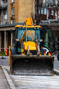 Excavator in traffic. industrial equipment at construction site in Bucharest, Romania, 2023