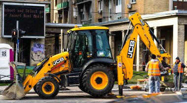 Excavator in traffic. industrial equipment at construction site in Bucharest, Romania, 2023