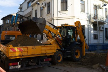 Construction workers at construction site and heavy duty bulldozer in Bucharest, Romania, 2023