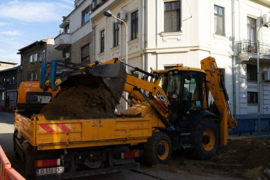 Construction workers at construction site and heavy duty bulldozer in Bucharest, Romania, 2023