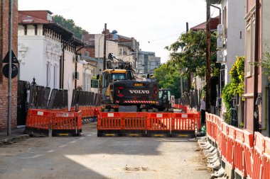 Construction workers at construction site and heavy duty bulldozer in Bucharest, Romania, 2023