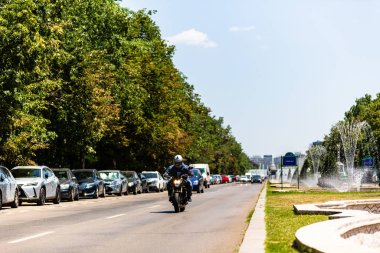 Biker on a motorcycle in traffic at rush hour in downtown area of the city in Bucharest, Romania, 2022