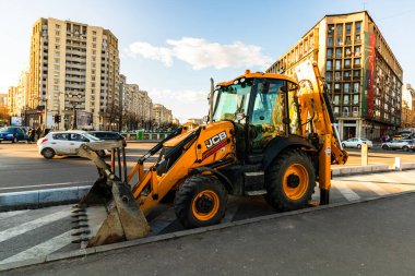 Excavator in traffic. industrial equipment at construction site in Bucharest, Romania, 2023