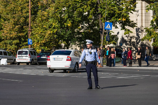 Police agent, Romanian Traffic Police (Politia Rutiera) directing traffic. Rush hour in Bucharest, Romania, 2022
