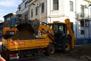 Construction workers at construction site and heavy duty bulldozer in Bucharest, Romania, 2023