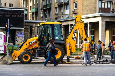 Excavator in traffic. industrial equipment at construction site in Bucharest, Romania, 2023