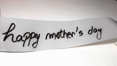 Happy mother`s day writing love text for mother on paper. Label tag with lovely message for mother`s day.