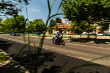 Biker on a motorcycle in traffic at rush hour in downtown area of the city in Bucharest, Romania, 2022