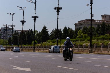 Biker on a motorcycle in traffic at rush hour in downtown area of the city in Bucharest, Romania, 2022