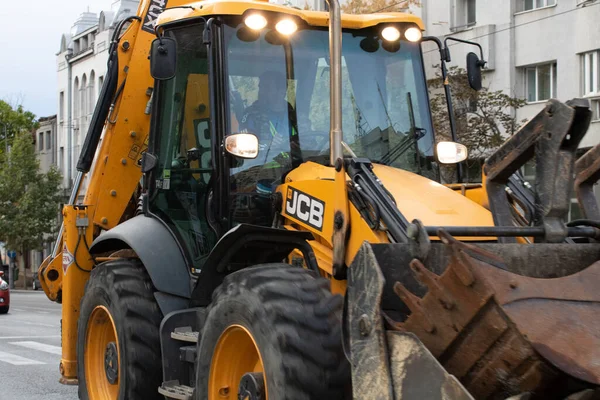 Construction workers at construction site and heavy duty bulldozer in Bucharest, Romania, 2023