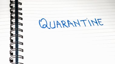Quarantine handwriting  text on paper, on office agenda. Copy space.