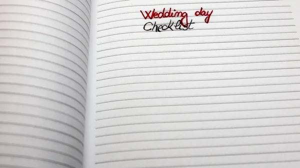 Text Wedding day checklist on page of agenda.  Copy space. Bucharest, Romania, 2020.