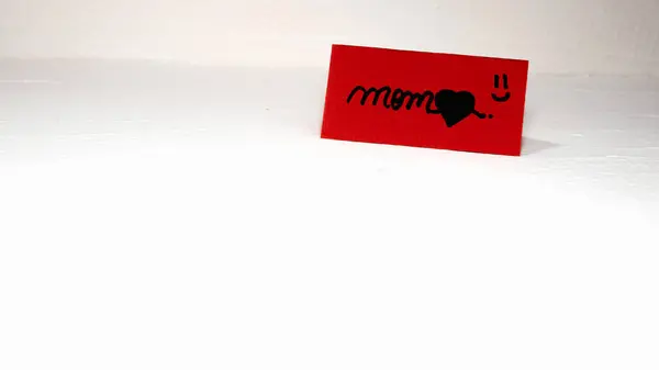 Mom writing love text for mother on paper. Label tag with lovely message for mother`s day.