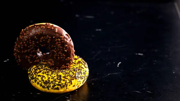 Frisch Leckere Farbige Donuts Mit Streusel Auf Schwarzem Hintergrund — Stockfoto