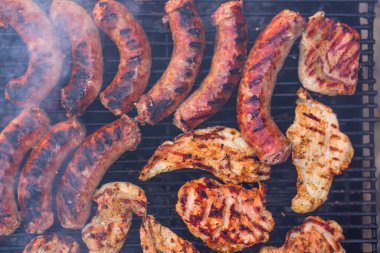 Izgara sosis ve ızgarada domuz pirzolası. Bahçede mangal partisi.